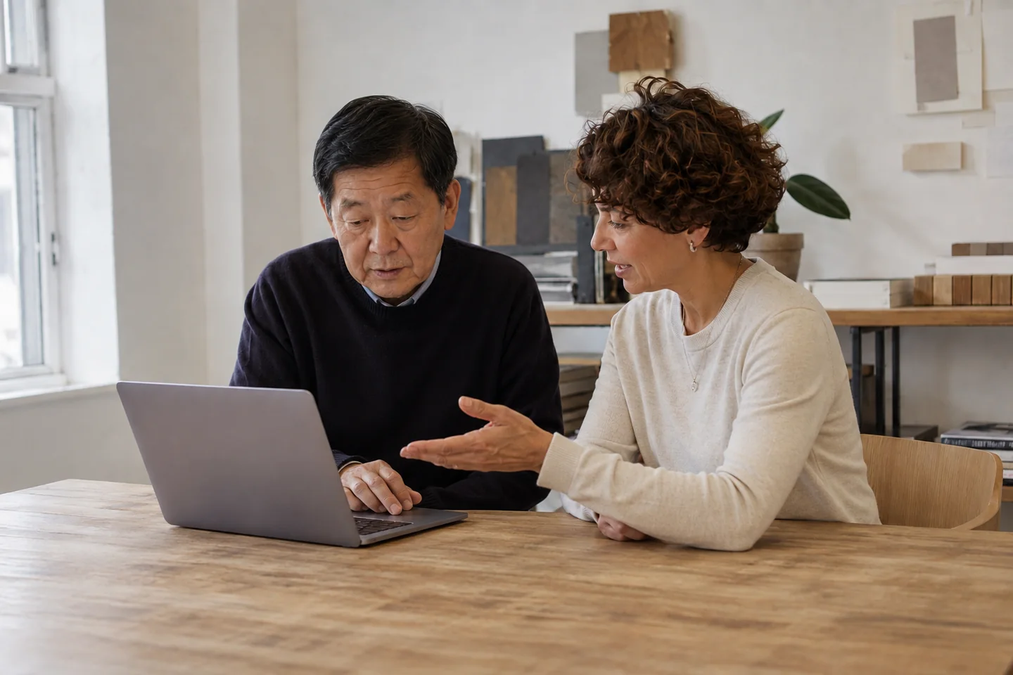Illustrative scene of two business partners reviewing company information on a laptop