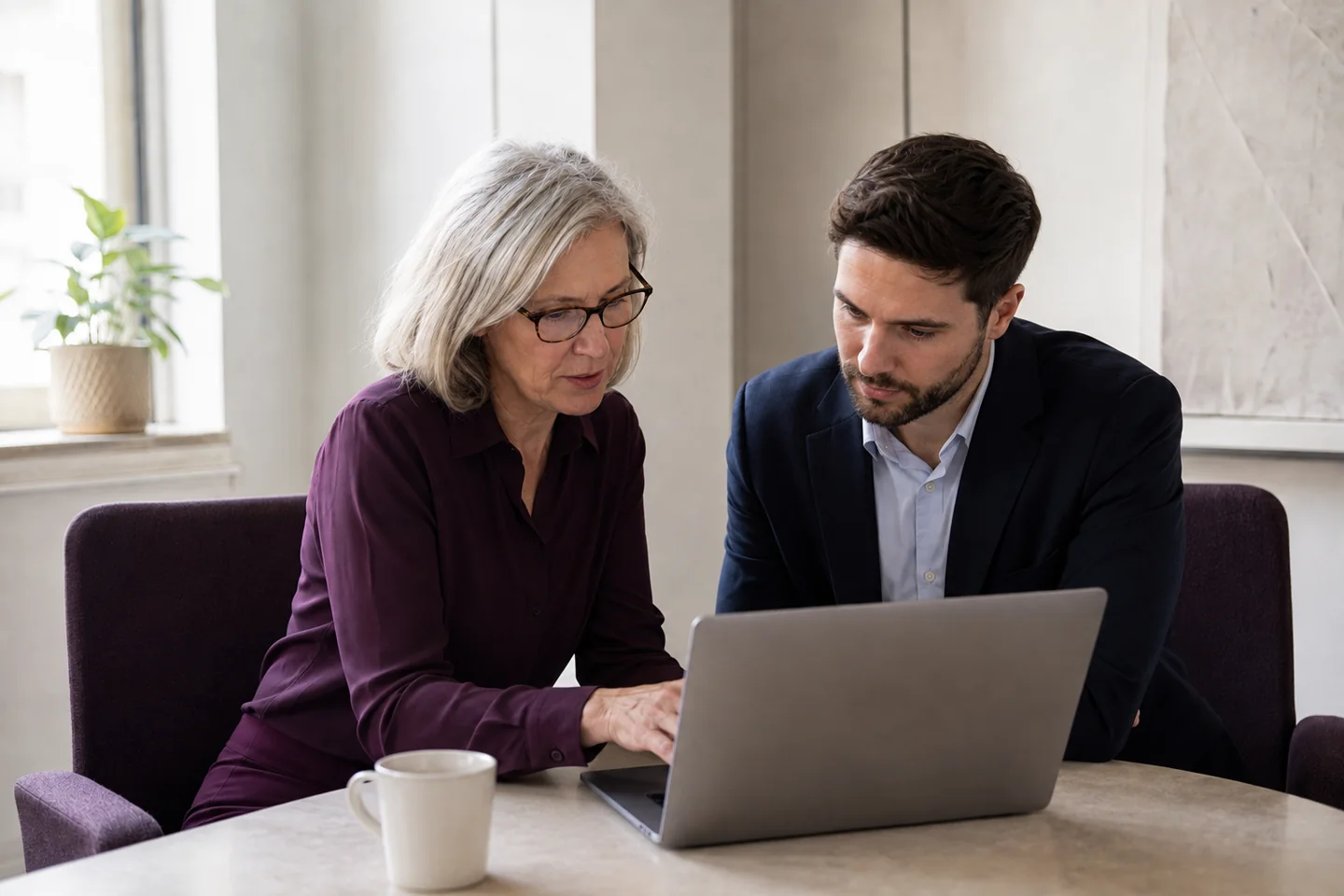 Illustrative scene of colleagues reviewing digital evidence together on a laptop