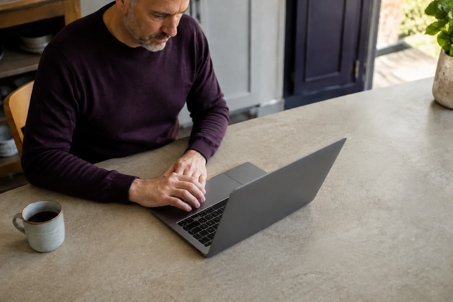 Illustrative scene of a client reviewing financial information on a laptop at home